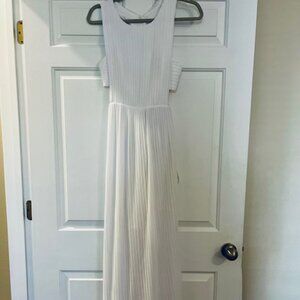 Long white dress with accordion pleats and side cut outs